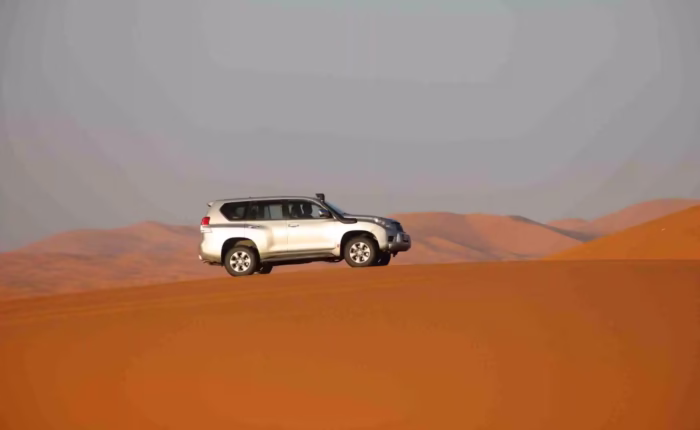 Silver Prado on the top of Merzouga Desert dunes during our 3 Morocco tour from Fes - Fes Desert tour - Morocco travel package - Morocco tour package - Morocco trip package - Morocco holiday packages / Moroccan travel tours