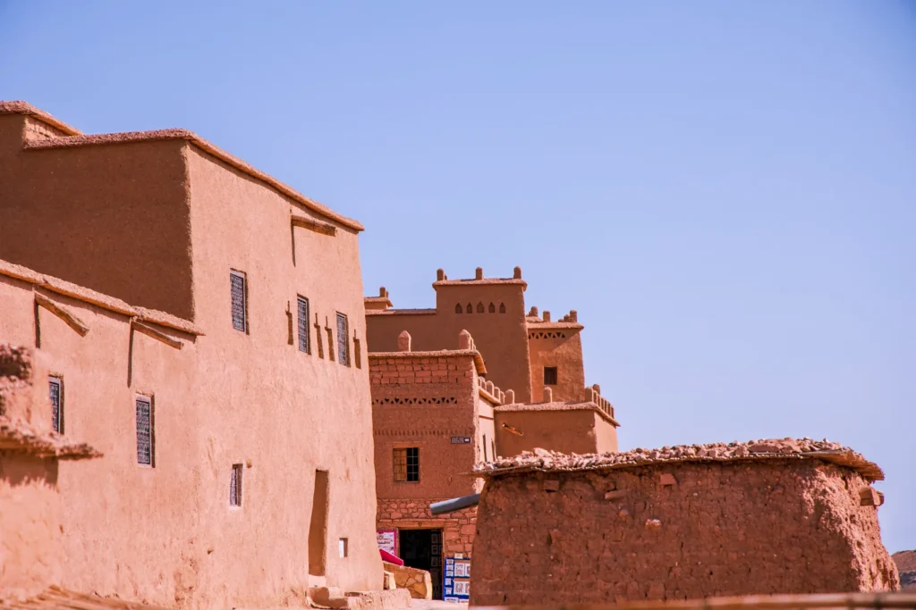 Earthen kasbah walls under a blue sky on the High Atlas road