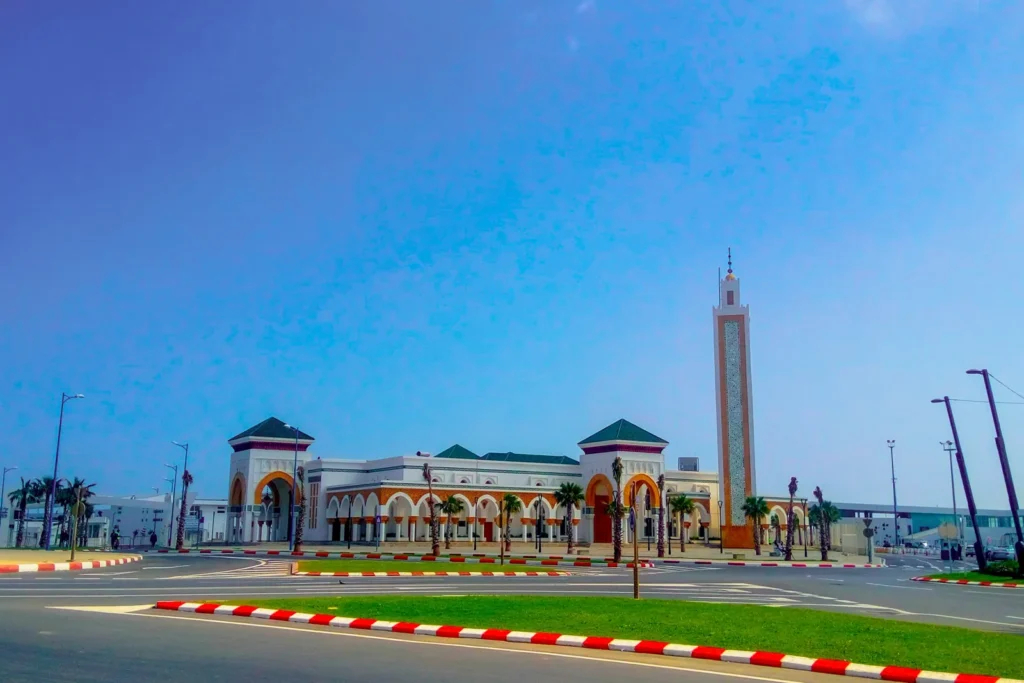 Mosque minaret beside a palm-lined avenue