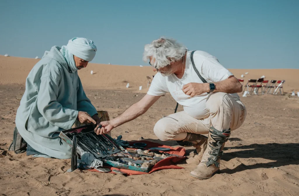 A Berber trader showing his crafts in the Sahara