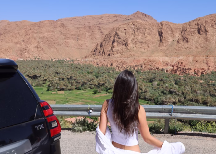 Moroccan travel image of a woman enjoying a panoramic view of Todra Valley during our 4 Morocco Desert tour from Marrakech to Fes. Best Morocco vacation package